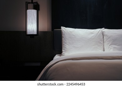 Night scene in hotel room, nightstand with lamp - Shutterstock ID 2245496453