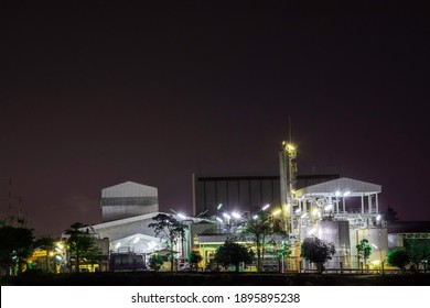 Night Scene Of Industry Factory Plant With Modern Warehouse, Environmentally Friendly Manufacturing Plant Of New Technology Production Line