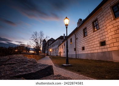 Night scene with lit lamp, pathwalk and ancient wall - Jindrichuv Hradec, Czech republic