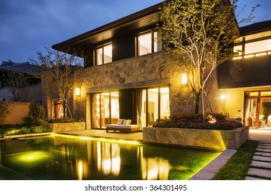 Night Scene Of Modern Building Near Pond At Night