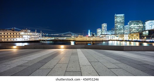 Night Scene Of Modern Office Buildings Near Water In San Francisco On View From Empty Marble Floor