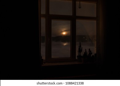 Night Scene Of Moon Seen Through The Window From Dark Room. Moonlight Inside Dark Room. Moon Over Clouds View From Dark Room