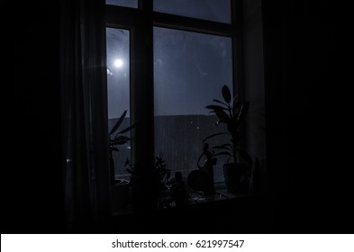 Night Scene Of Moon Seen Through The Window From Dark Room. Moonlight Inside Dark Room