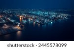 night scene shipping port, container warehouse, cruise ship is sailing out of the port, motion effect low shutter speed to want movement of the cruise ship, blue tone process, aerial view