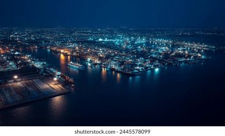 night scene shipping port, container warehouse, cruise ship is sailing out of the port, motion effect low shutter speed to want movement of the cruise ship, blue tone process, aerial view - Powered by Shutterstock