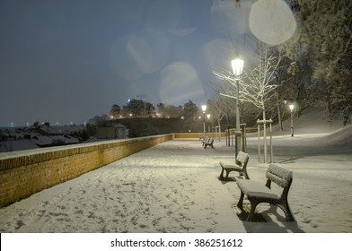 Night scenery of snowy Prague streets with bokeh