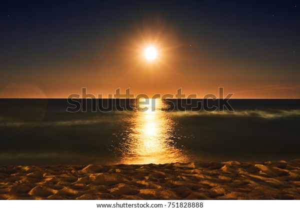Night sea landscape
and horizon. Beautiful, bright reflection of the great moon of
golden color on the surface of the sea of golden color             
                 