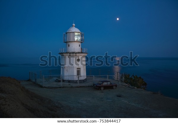 Night sea landscape - lighthouse in the light of\
the moon.