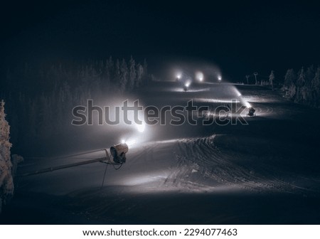 night shift snow makeing hard work