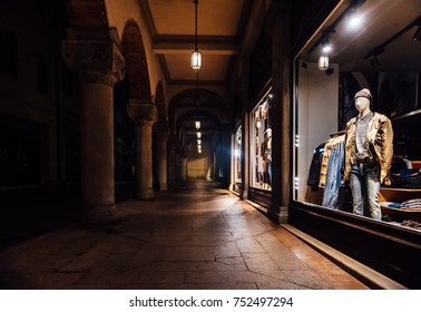 night shop window with clothes in italy