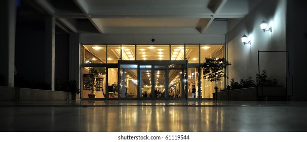 Night shot of the entrance and facade to a luxury european hotel.