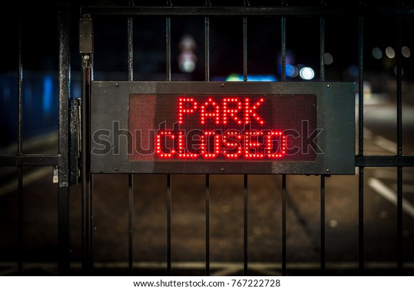Night sign of park closure,\
London