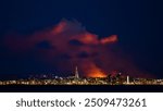 The night sky above Reykjavík lit up by a nearby volcanic eruption on the Reykjanes peninsula, Southwest Iceland