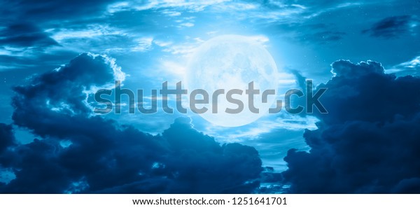 Night sky with blue moon in the clouds \
