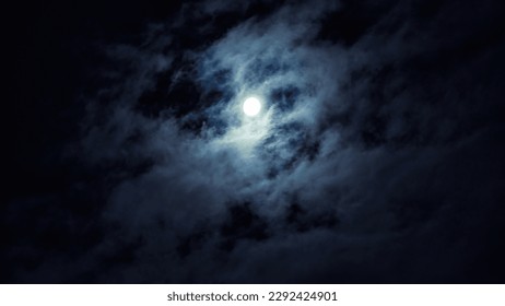 Night sky with full moon for background, concept of horror, Halloween, mystery and nature. Dramatic spooky clouds in moonlight from full moon. Dark gothic sky wallpaper. - Powered by Shutterstock