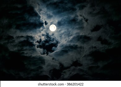 Night Sky With Full Moon. Concept Of Spooky, Horror, Halloween Theme And Mystery. Dramatic Clouds In The Moonlight From Full Moon. Dark Gothic Surreal Background.