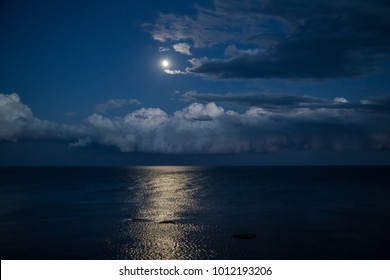 Night Sky With Full Moon And Reflection In Sea.