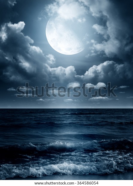 Night sky with full moon and reflection\
in sea. Elements of this image furnished by\
NASA