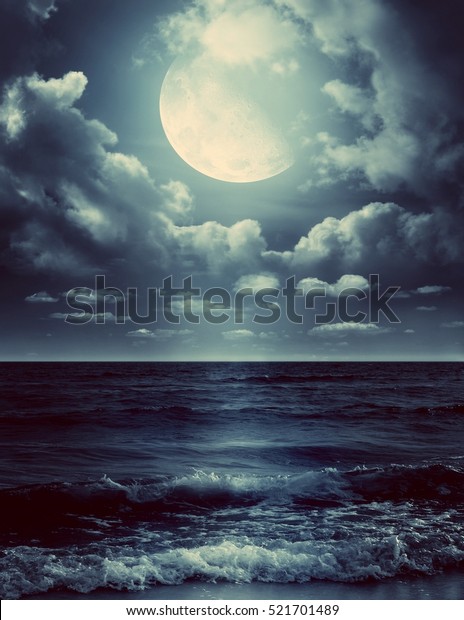Night sky with full moon and reflection\
in sea. Elements of this image furnished by\
NASA