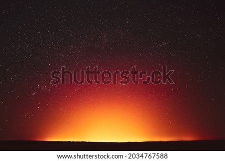 Night Sky With Glowing Stars Background Backdrop. Sky Gradient. Sunset, Sunrise Lights And Colourful Night Starry Sky In Yellow Orange Colors. Copy Space.