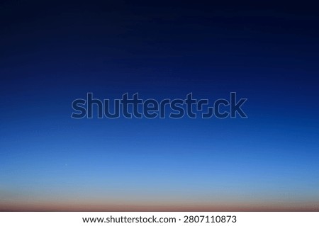Night sky gradient transition from dark blue to twilight horizon. Atmospheric background featuring star light and dusk glow. Evening sky stage for cosmic texture and celestial design.