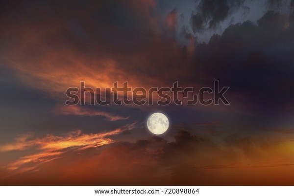  Night sky and light of the moon . Full moon\
background  . Red sunset and moon . Glowing sunset and full moon  .\
Dramatic nature background 
