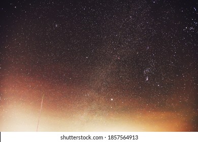Night sky with Milky Way, Orion constellation and Orion Nebula, Sirius star, Pleiades and the Leonids meteor shower.
