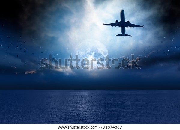 Night sky with moon in the clouds with\
airplane Elements of this image furnished by\
NASA