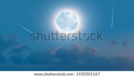Night sky with moon in the clouds with falling star 