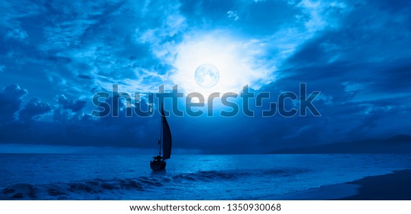 Night sky with moon in the clouds\
with lone yacht \