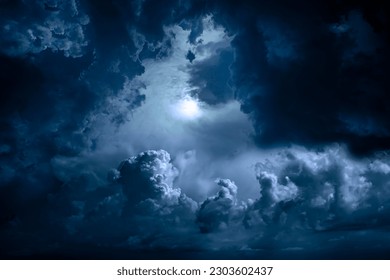 Night sky with moon light. Dramatic clouds in mystic moonlight. Large bright moon as concept of mystery, midnight, gothic time and spooky theme. Moody sky texture background. - Shutterstock ID 2303602437