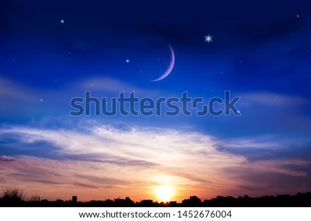 the night sky over the village .  New moon .  Religion background . The sky at night with stars. Ramadan background . 