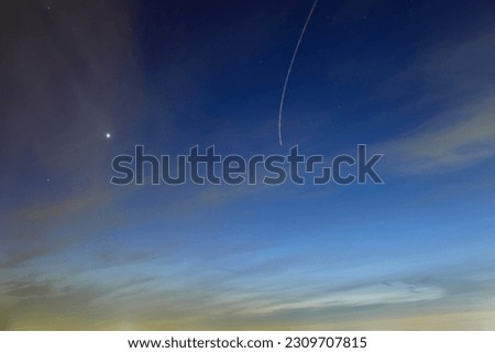 Night sky with stars and traces of flying planes