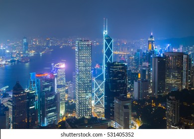 Night skyscrapers with illumination and sea coast in Hong Kong, China, view from Queen Garden