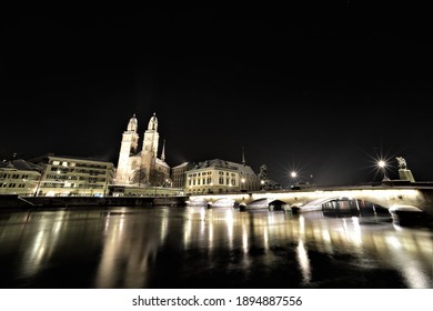 At Night In Snow On The Limmat With A View Of Grossmünster, Münsterbrücke And Limmatquai In Zurich