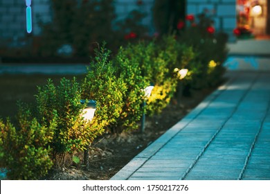 At night solar light outdoor shining beside the pathway stones to the courtyard apartments. - Shutterstock ID 1750217276