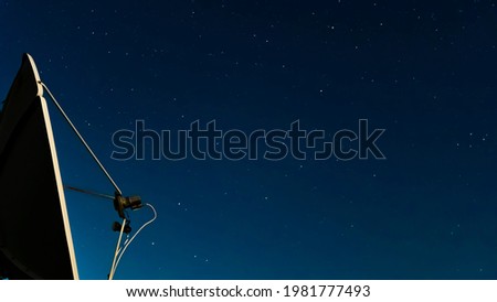 The night starry sky against of a satellite dish.Exploring the cosmos and the stars.Astrology,astrophotography and the study of galaxies in the sky.Movements of stars and planets at night.astrophoto