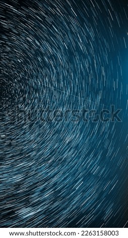 Night Starry Sky Stars And Meteoric Track Trails. Meteors Fly Across Sky. Spin Trails Of Stars. Star Trails On Night Sky Background. Dark Blue . Amazing Stars Effects In Sky. Stars Rotate Of