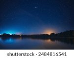 Night Stars Above Lake. Natural Starry Sky Background Backdrop Landscape.