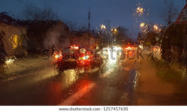 night storm raining window car driving\
concept with the background of the night city \
