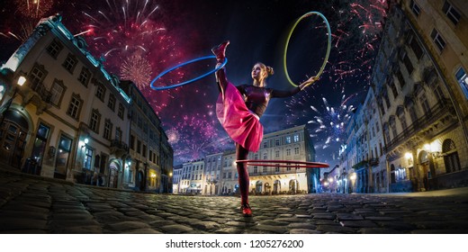 Night Street Circus Performance Whit Clown, Juggler. Festival City Background. Fireworks And Celebration Atmosphere. Wide Engle Photo