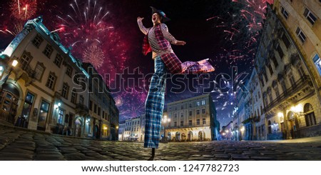 Night street circus performance whit clown. Festival city background. fireworks and Celebration atmosphere.
