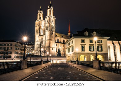 Night Street View Of Grossmünster Church And Surrounding Buildings. Zurich, Switzerland