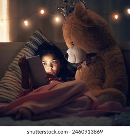 Night, teddy bear and girl with tablet, kid and relaxing with screen light, online reading and social media. Bedroom, home and child with tech, stuffed animal and dark with internet and digital app - Powered by Shutterstock