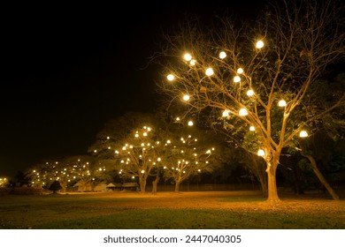 Night theme garden decoration with tree decorated with light bulb. - Powered by Shutterstock