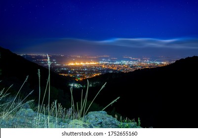 Night Time City Scape Of Flickering Urban Light Sin The Distance