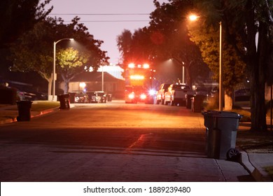 A Night Time Collection Of Trash By A Garbage Truck In A Suburban American Neighborhood.