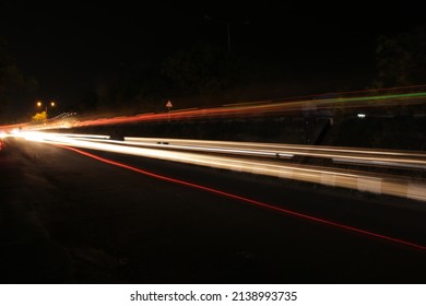 In Night Time At  Highway Road The Car And Other Vehicles Are Passing With Bright Light Took This Picture In Long Exposure ,light Painting