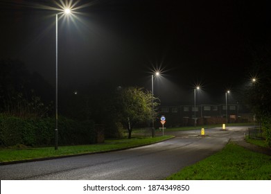 Night Time Image Of Suburban Street With Roundabout And Street Lights