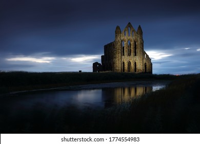 Night Time image of Whitby  Abbey with Floodlights and reflection. Whitby, North Yorkshire, England, UK.